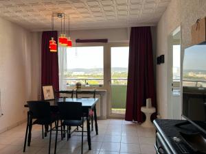 a dining room with a table and chairs and a window at Central Studio for 2 in Hattersheim