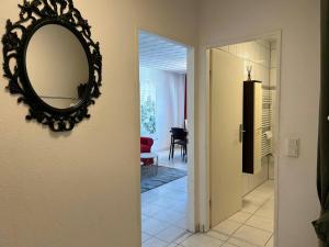 a mirror hanging on a wall next to a hallway at Central Studio for 2 in Hattersheim