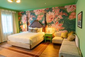 a bedroom with a bed and a couch at Carlton Hotel in Atascadero +49 photos