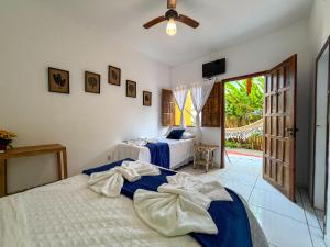 a bedroom with two beds and a ceiling fan at Pousada João Maria in Trancoso +40 photos