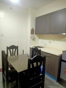 a kitchen with a table and chairs and a counter at Condotels RQ Hob in Manila +2 photos