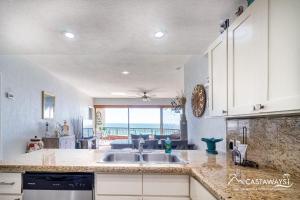 a kitchen with a sink and a view of the ocean at Sonoran Spa E204 in Puerto Peñasco
