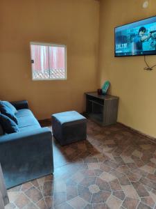 a living room with a couch and a flat screen tv at Mi Hábitat in Asuncion
