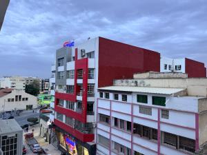 a red and white building on a city street at Suite Bahiya 11 in Fès