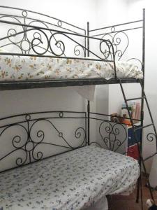 a bedroom with two bunk beds with a floral mattress at Appartamento Nosside in Locri