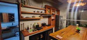 a kitchen with a wooden counter and a wooden table at Villa Arcadia in Los Baños