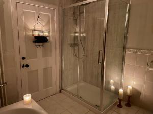 a bathroom with a shower with a glass door at Room 1, Wedale House in Stow +16 photos