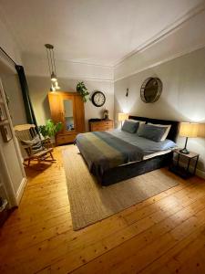 a bedroom with a large bed and a wooden floor at Wedale House, first floor in Stow
