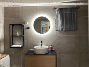 a bathroom with a sink and a mirror at Cozy apartment with sauna in Haapavesi +16 photos