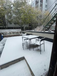 a table and chairs covered in snow on a roof at Exclusive Queen St Downtown Full House-PRIVATE PATIO in Toronto