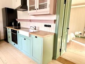 une cuisine avec des armoires bleues et un évier dans l'établissement Lake stay in Viljandi with Parking, à Viljandi 5 autres photos