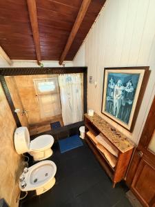 a bathroom with a toilet and a sink at Tres Coronas in San Martín de los Andes