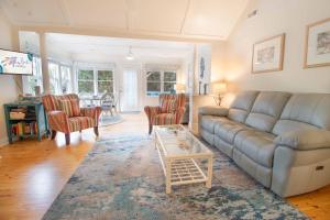 a living room with a couch and a table and chairs at Paws4ever II in Edisto Island