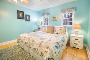 a blue bedroom with a bed and a window at Paws4ever II in Edisto Island