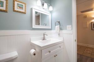 a white bathroom with a sink and a mirror at Paws4ever II in Edisto Island +19 photos