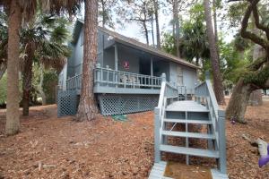a house with a staircase in front of it at Paws4ever II in Edisto Island
