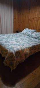 a bed in a bedroom with a blanket on it at Casa Guanaqueros in Coquimbo +13 photos