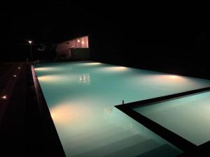 a swimming pool at night with lights on it at The Wild Elephant Resort in Sigiriya +34 photos