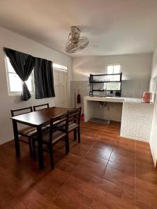 a kitchen and dining room with a table and chairs at Sandy house pai 3 in Kampong Huaibū