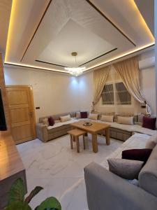 a living room with couches and a table at El jebha in El Jebha +5 photos