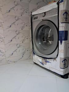 a washing machine sitting next to a marble wall at El jebha in El Jebha