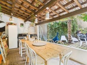 a dining room with a wooden table and chairs at Maison Événementielle à Paris avec jardin terrasse et métro in Montreuil