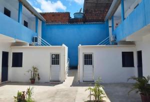 a blue and white building with two doors at Ilheus - Pousada Sol e Mar in Ilhéus