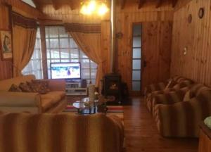 a living room with couches and a television at Casa Guanaqueros in Coquimbo