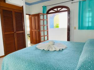 a towel on top of a blue bed at Hotel Jacqueline in Rincon de Guayabitos +3 photos