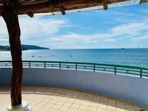 a view of the ocean from a balcony at Hotel Jacqueline in Rincon de Guayabitos