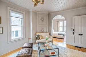 a living room with a couch and a table at Guestroom in Old Town | Steps to Lake & Everything in Niagara on the Lake