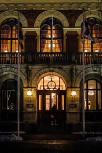 a building with two flags in front of it at Haparanda Stadshotell in Haparanda