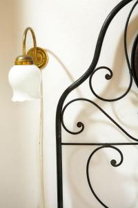 a lamp with a candle on a metal rack at Casa Delle Aque in Montecatini Val di Cecina