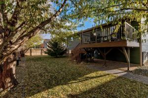 a deck on a house with a tree at Just Like Home, Centrally Located Family Friendly! in Rapid City