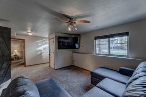 a living room with a couch and a ceiling fan at Just Like Home, Centrally Located Family Friendly! in Rapid City