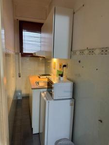 a small kitchen with a sink and a refrigerator at RUS Apartment in Florence +2 photos