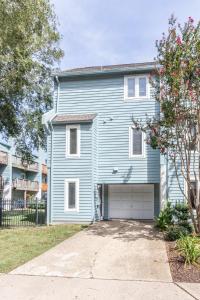 a blue house with a garage at Latitude Adjustment in Virginia Beach