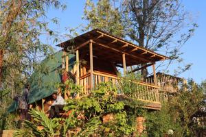 a tree house with people sitting in it at Malasy camping site in Makungulu