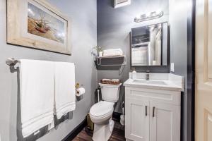 a bathroom with a white toilet and a sink at Long Beach Apartment - 10 Min Walk to the Beach! in Long Beach +23 photos