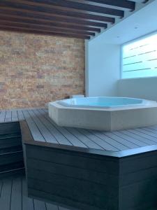 a large bath tub sitting on a wooden deck at Puerto Vallarta Del Canto Luxury in Bucerías