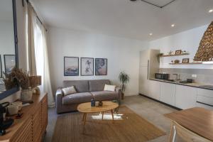 a living room with a couch and a table at Alma Home Experience in Ventimiglia