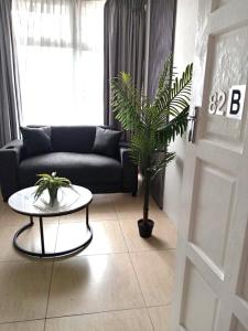 a living room with a couch and a table with a plant at Durban Oceanic 82B in Durban
