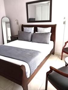 a bedroom with a large bed with a mirror on the wall at Durban Oceanic 82B in Durban
