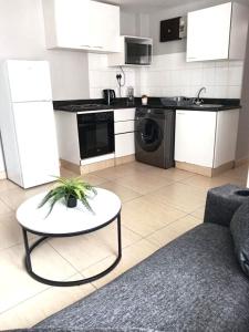 a living room with a table and a kitchen at Durban Oceanic 82B in Durban