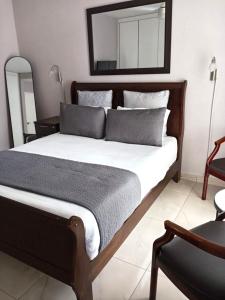 a bedroom with a large bed with a mirror on the wall at Durban Oceanic 82B in Durban