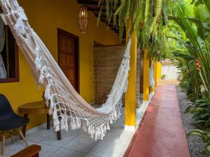 a hammock hanging from a house in a courtyard at Pousada João Maria in Trancoso