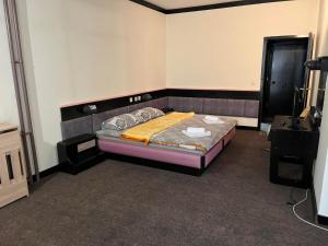 a small bedroom with a bed in a room at Konačište Lim in Čitluk