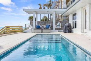 a swimming pool in front of a house at Seaside Retreat in Santa Rosa Beach