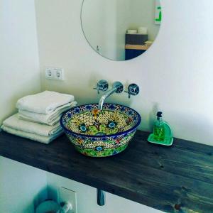 a bathroom counter with a sink and a mirror at Wooden Cottage Near The Baltic Sea in Lensahn
