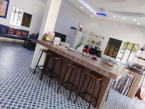 a kitchen with a counter and a refrigerator at keur Baye fall fall saly in Sali Nianiaral